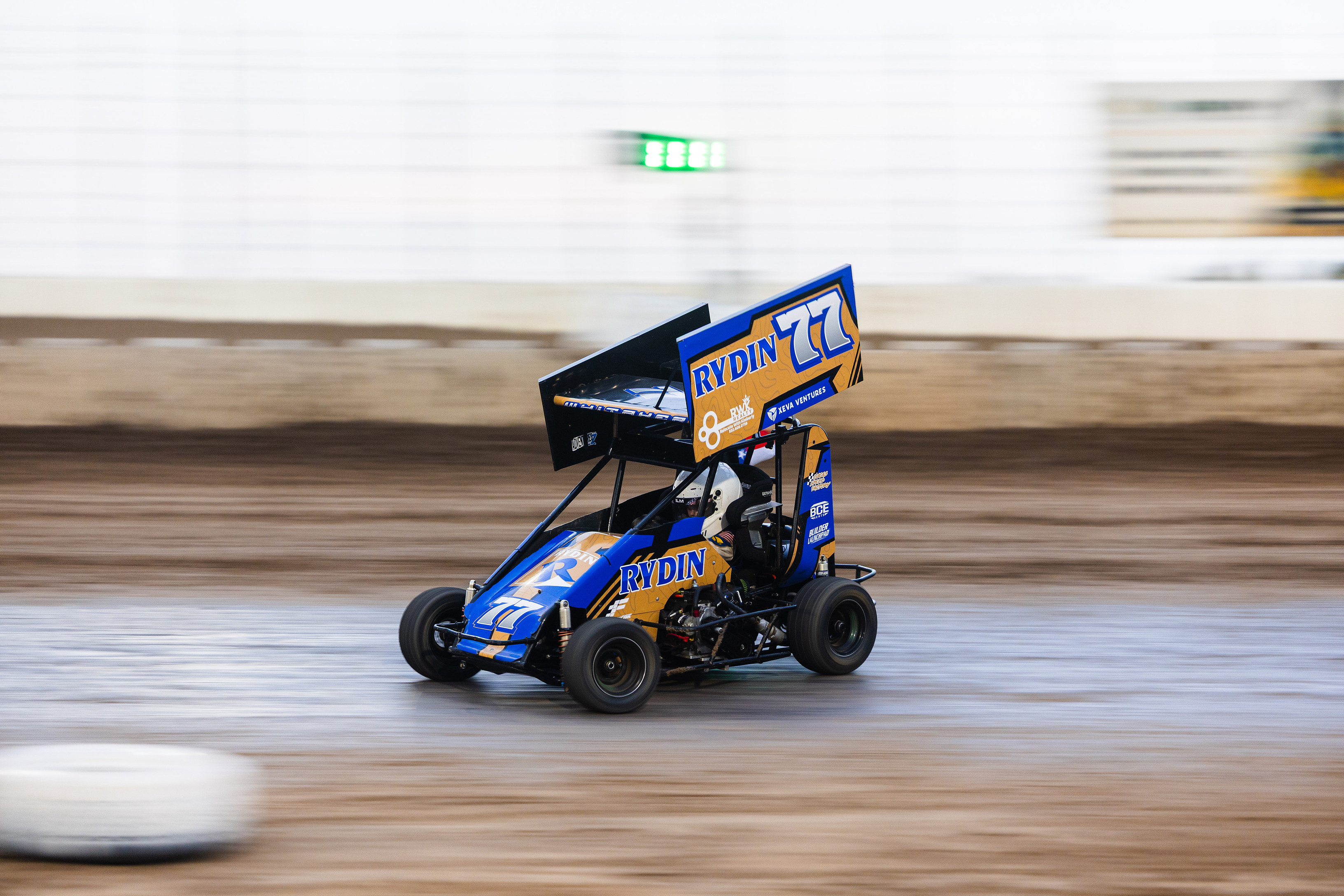Wesson’s blue and gold No. 77 micro sprint at speed on the dirt track